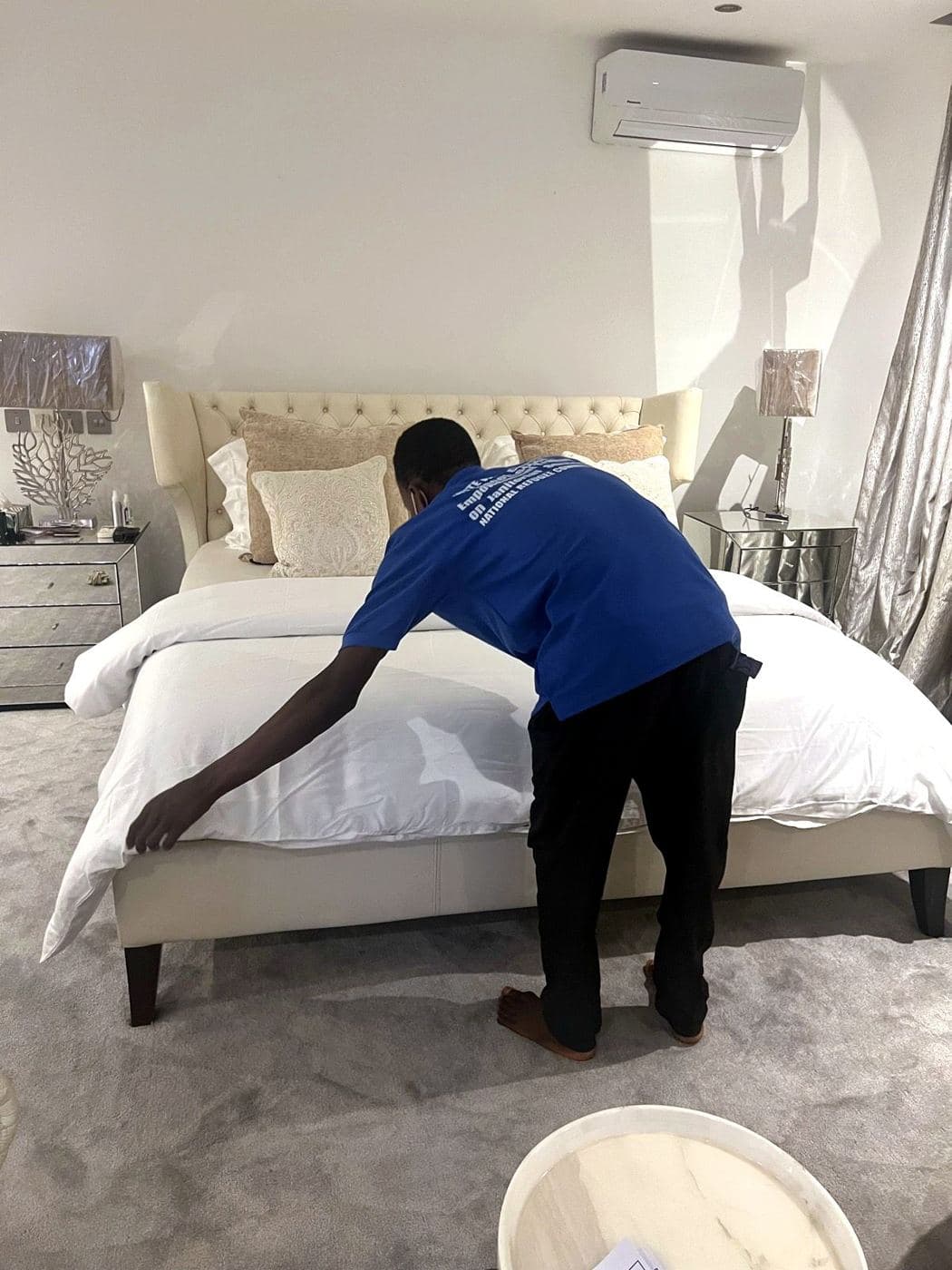 A White Wall cleaner making a bed